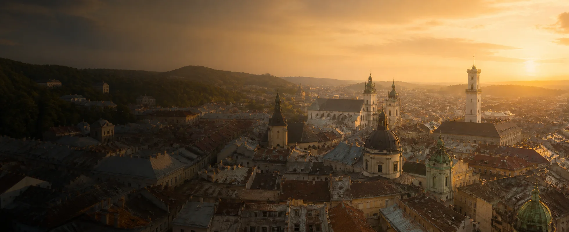 L’viv skyline, church domes and Town Hall tower in warm sunset light